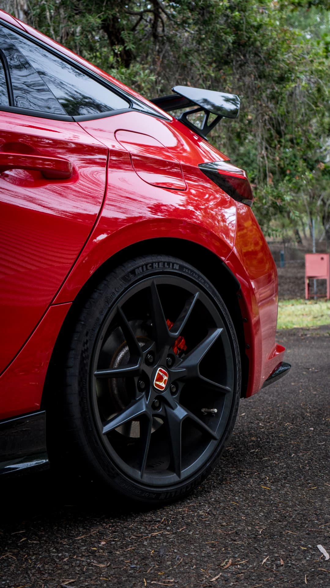 Red Civic Type R rear quarter with wing and Michelin-shod alloy