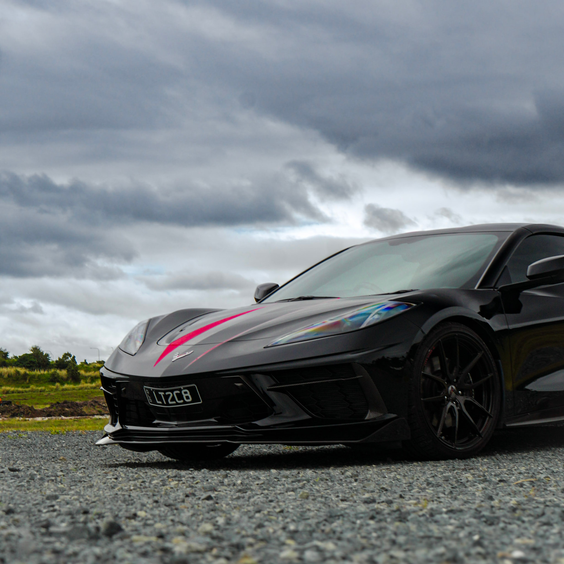 Corvette C8 low front three-quarter under heavy cloud