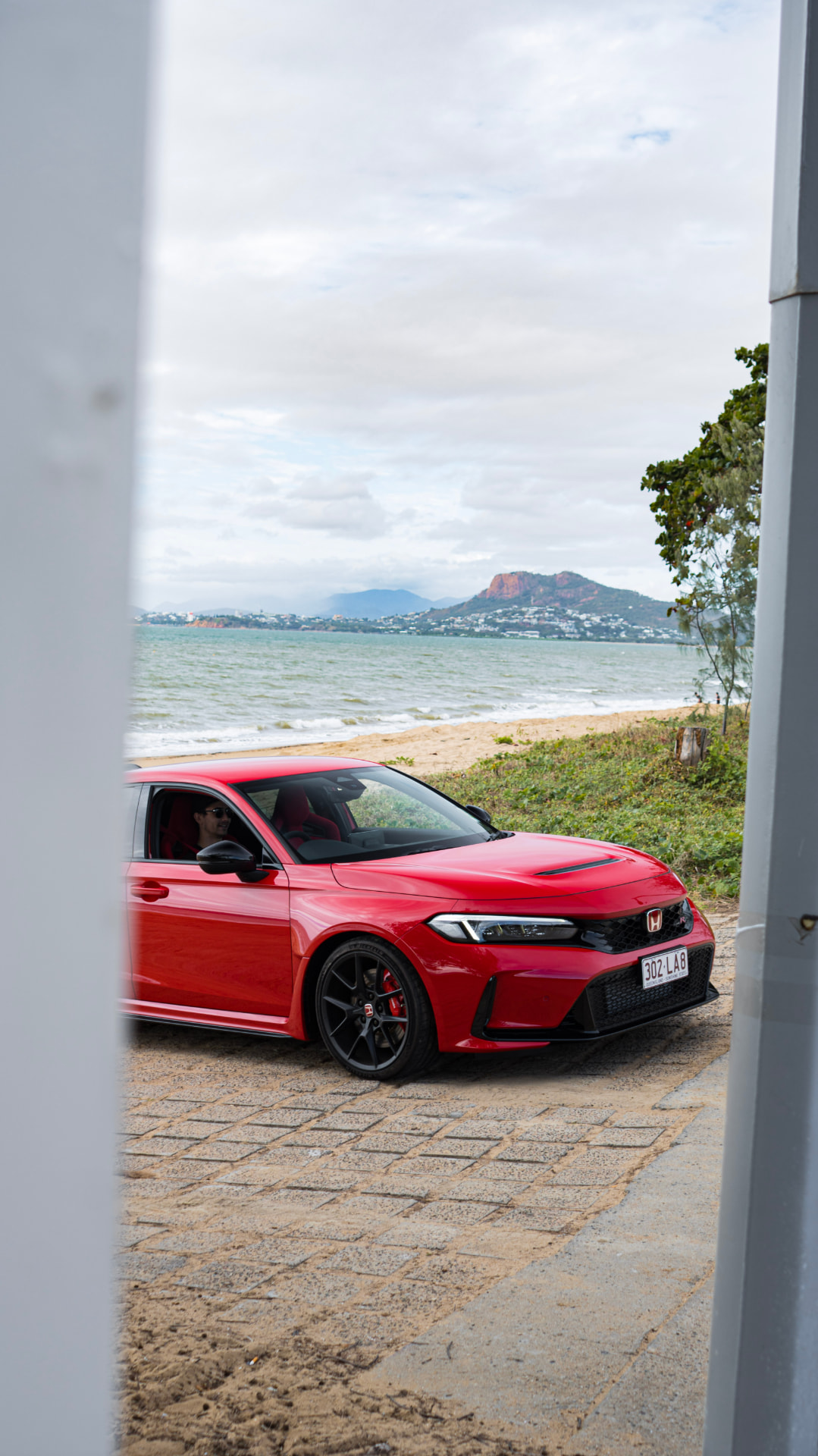 Civic Type R framed between pillars by the sea