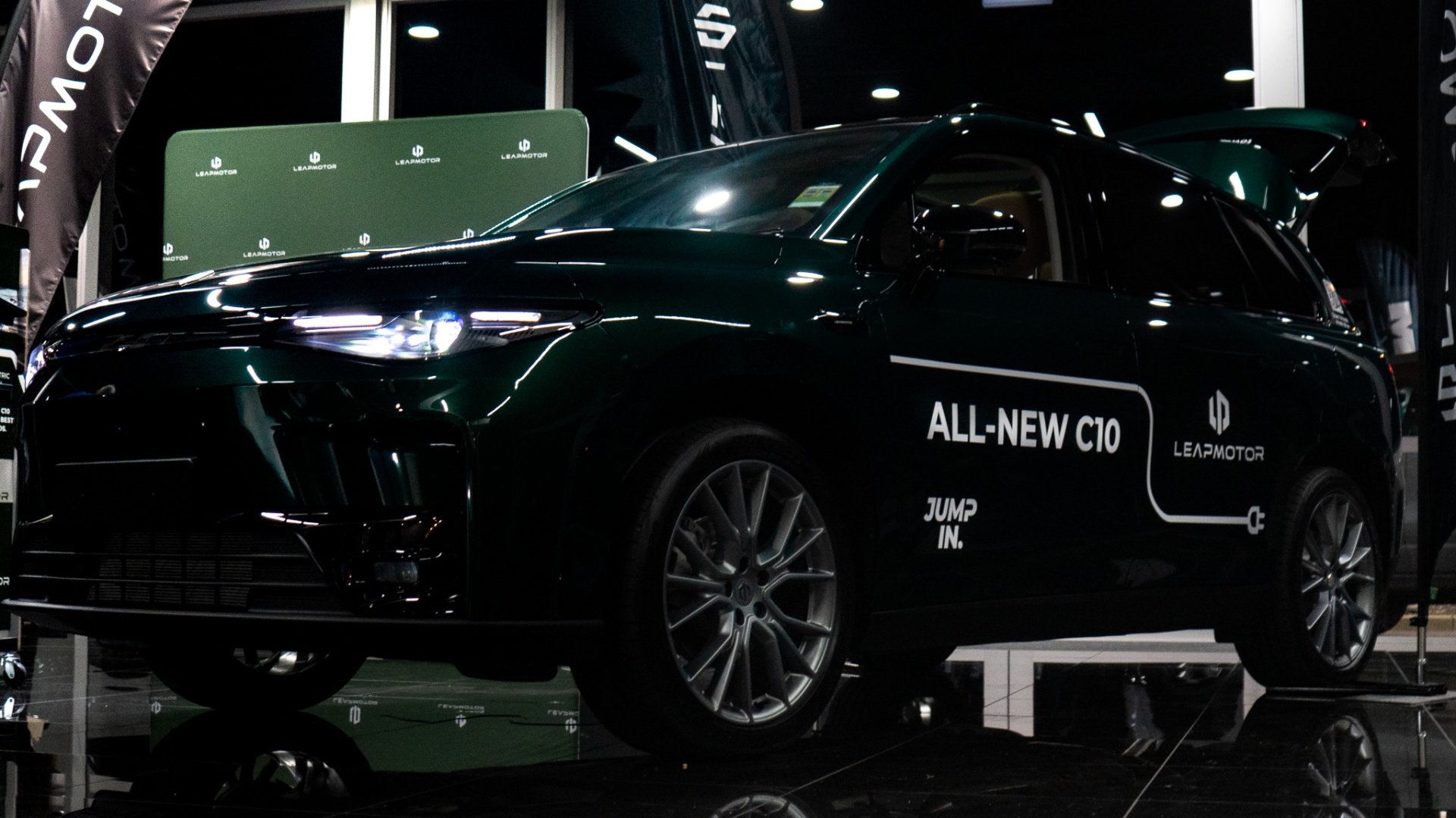 Leapmotor C10 in green, side profile under showroom lights