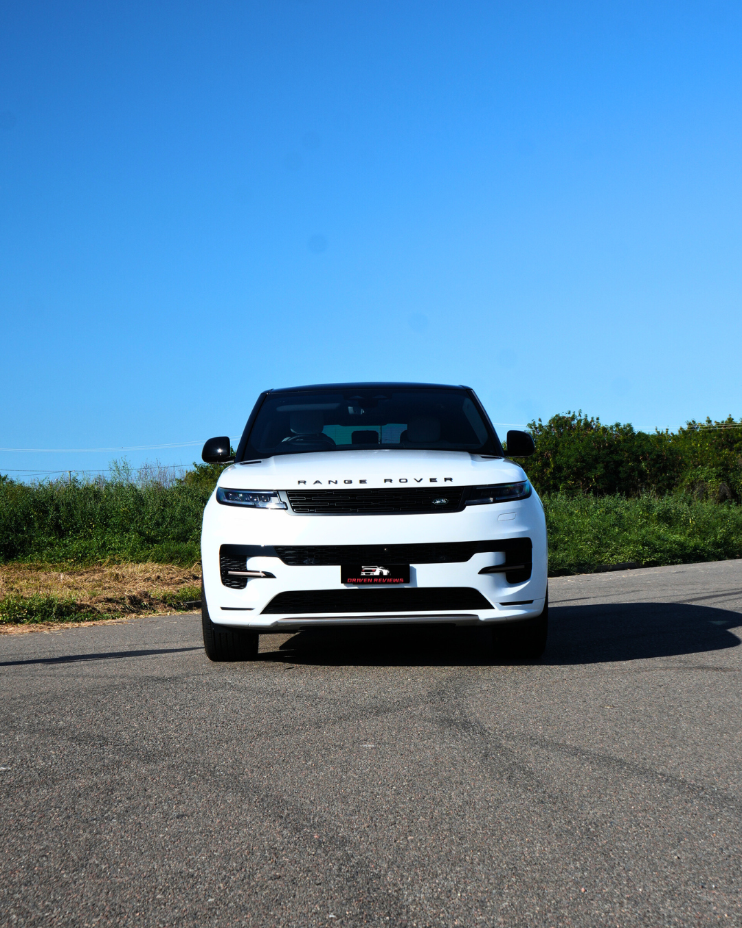 Range Rover Sport head-on under a clear blue sky