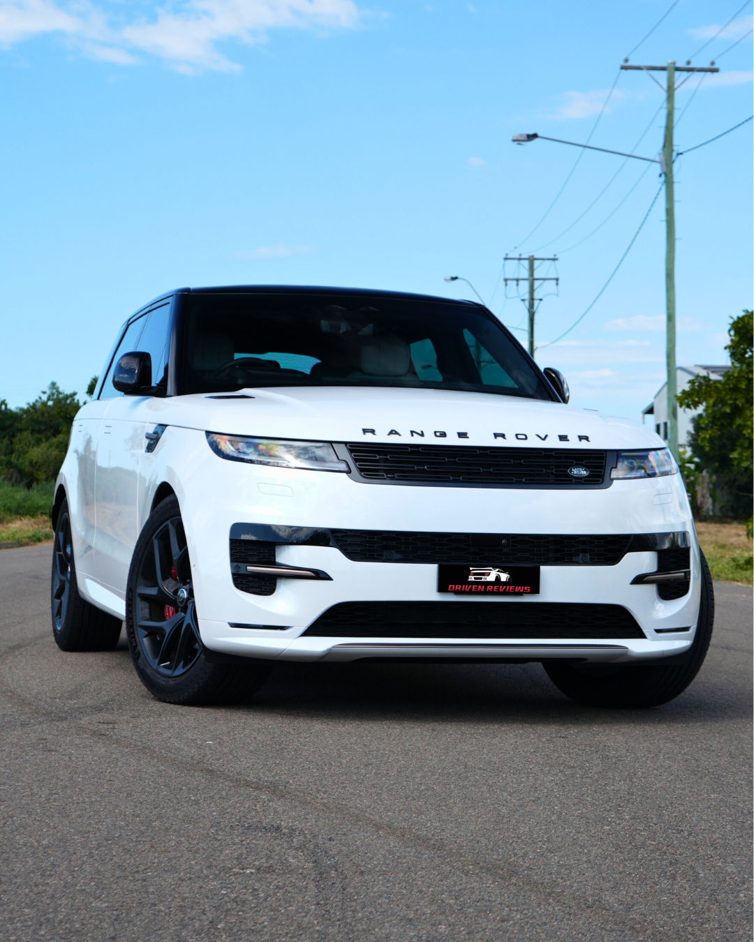 White Range Rover Sport front three-quarter on the road