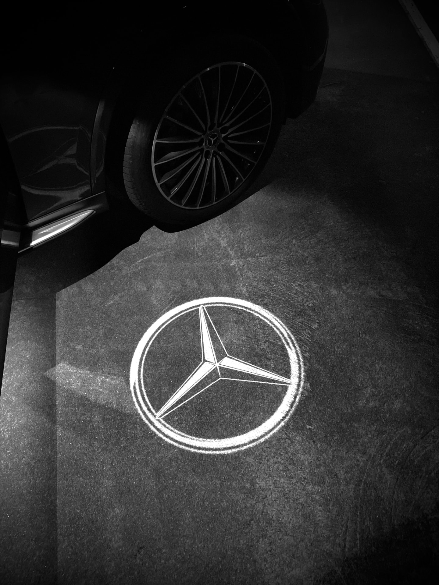Mercedes star puddle light projected beside the GLC's wheel