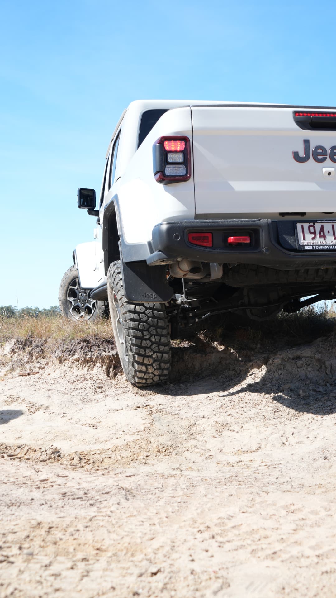 Jeep Gladiator Rubicon rear end climbing a sand bank