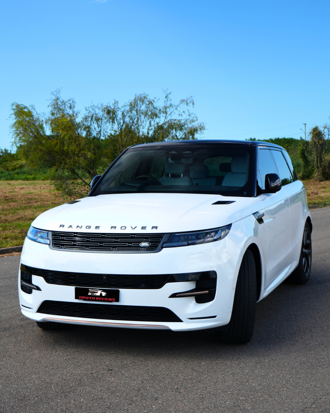 Range Rover Sport angled in front of trees