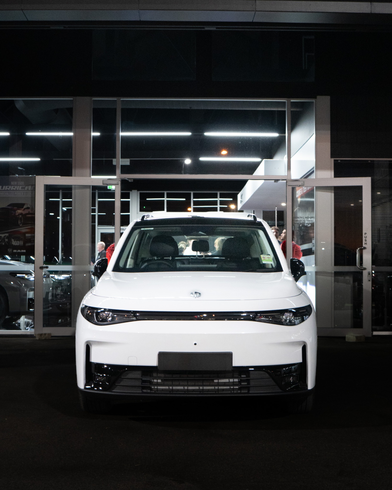 Leapmotor C10 in white, head-on at the dealership entrance